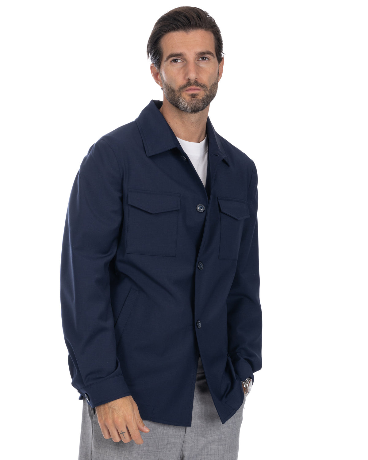 Navy blue men's button-up shirt jacket with chest pockets, long sleeves, and collared design. Casual lightweight outerwear.