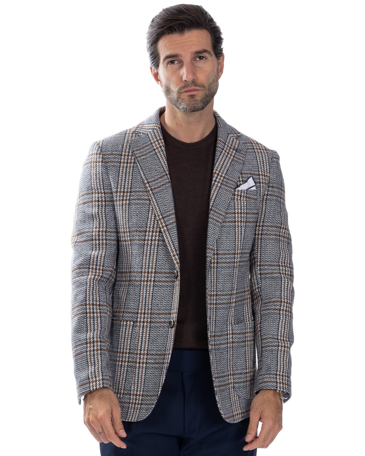 Men's grey and brown plaid wool blazer with notched lapels, white pocket square, and two-button closure.