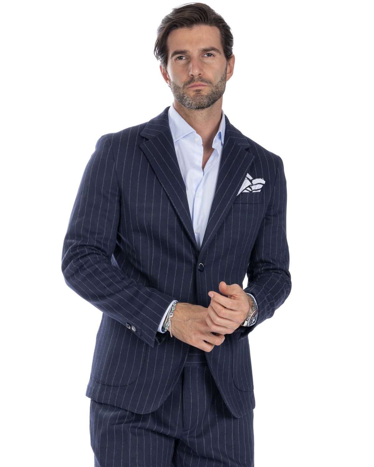Navy pinstripe wool suit with light blue dress shirt, notched lapels, and pocket square. Men's formal business attire.