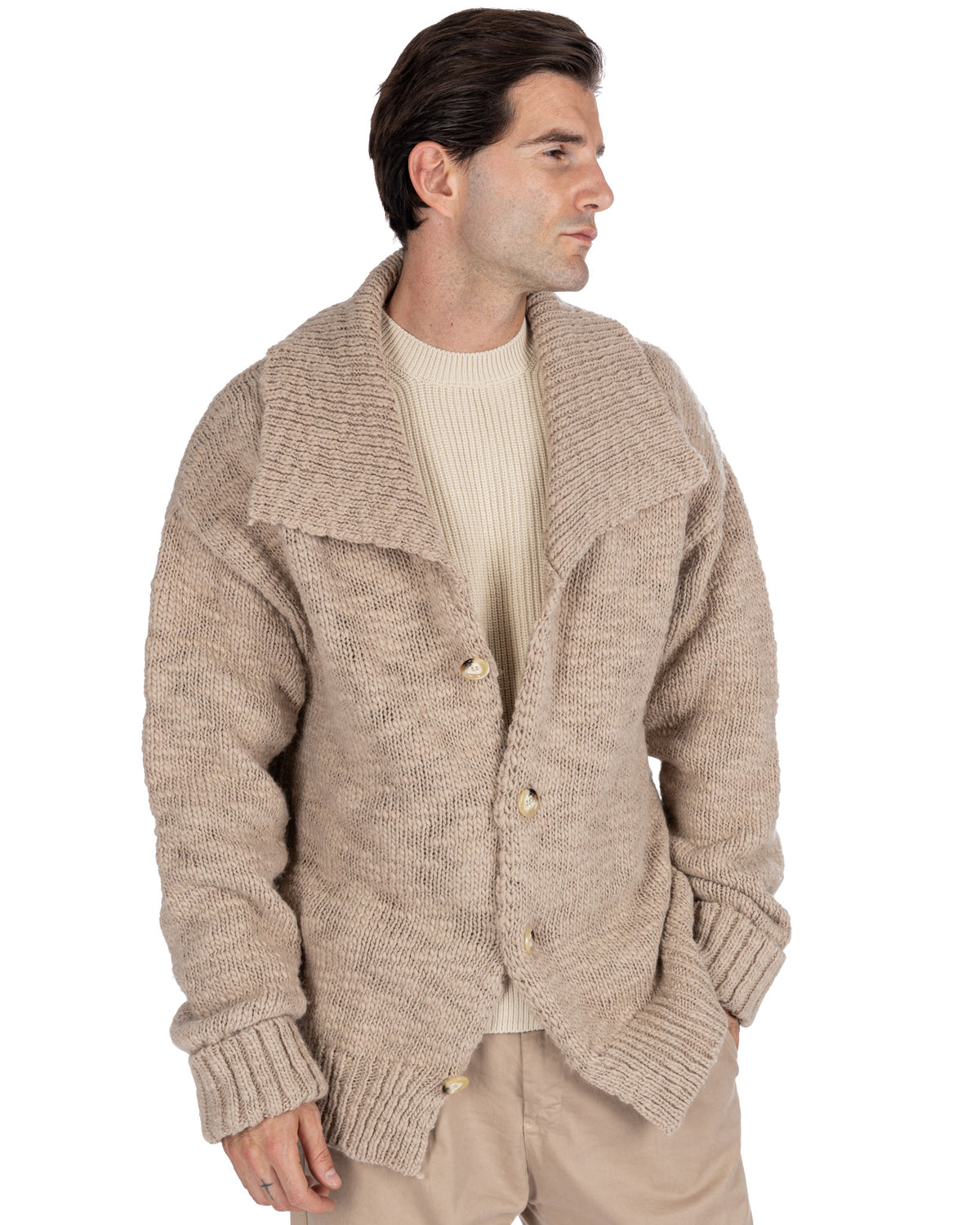 Beige chunky knit cardigan with wide collar, button front, and ribbed cuffs. Cozy wool-blend sweater jacket for men.