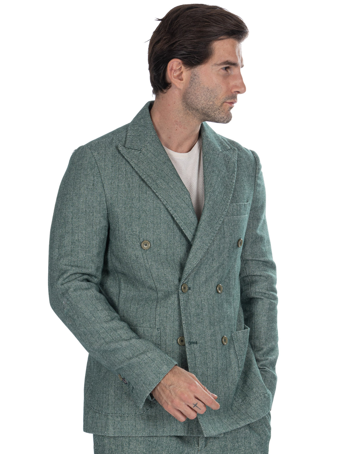 Green herringbone double-breasted blazer with brass buttons, tailored fit, worn over white shirt.