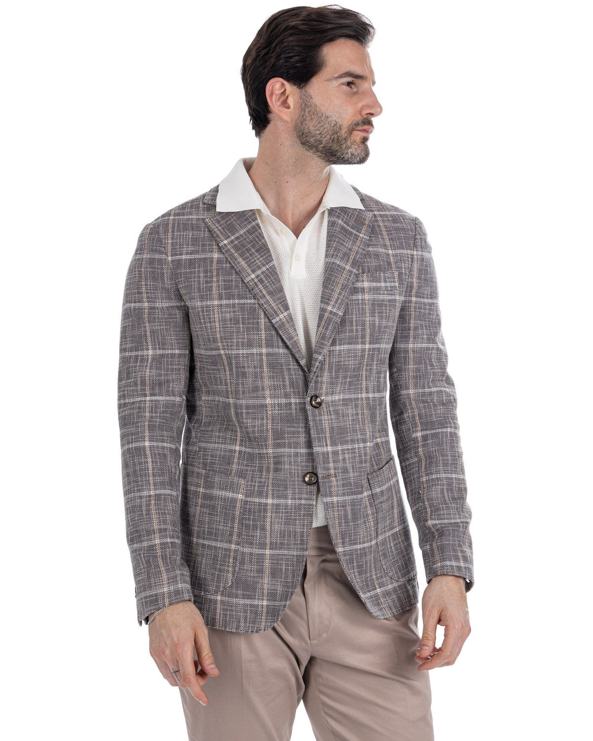 Men's gray plaid linen blazer with notched lapels, two-button closure, paired with white polo and beige trousers.