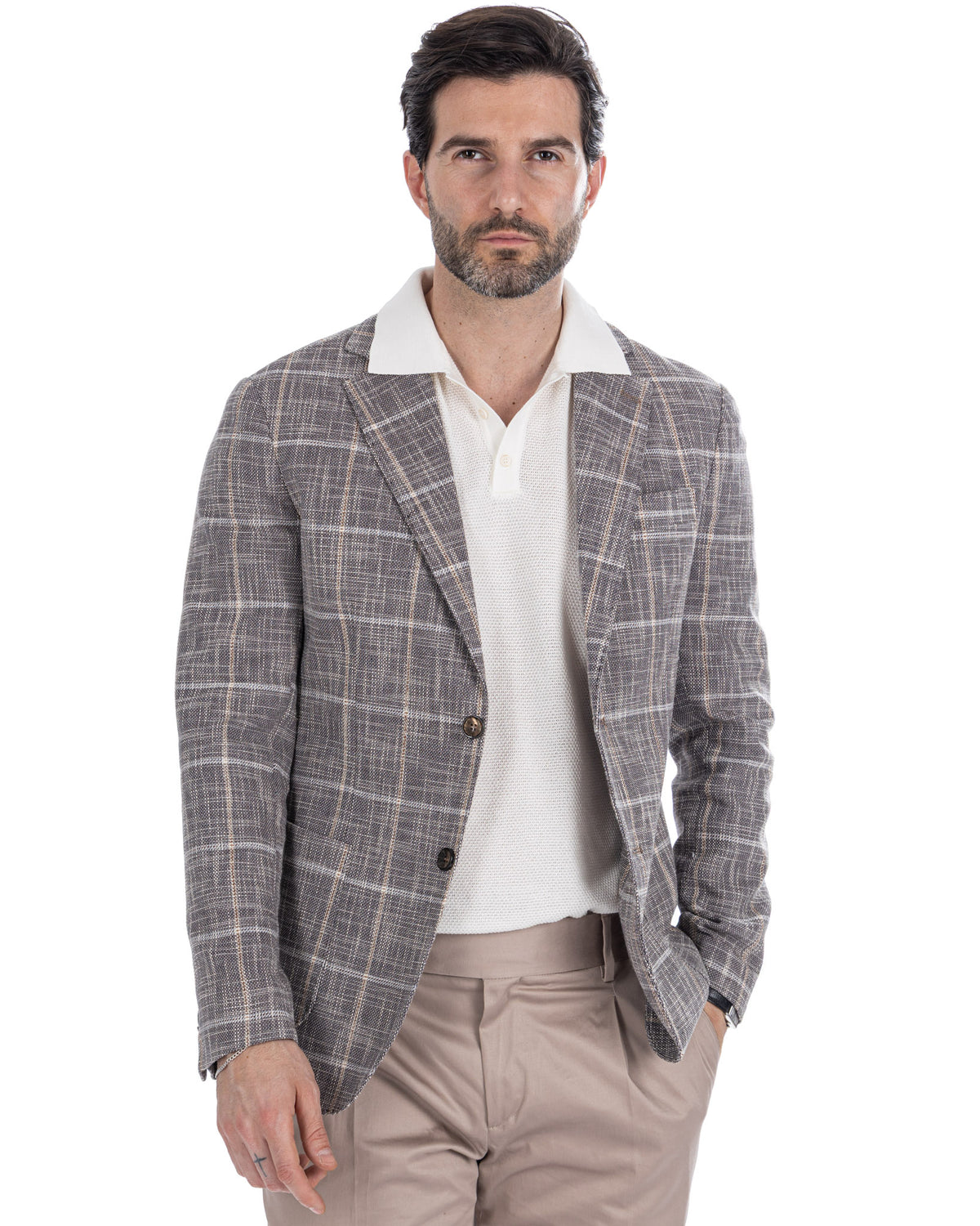 Men's gray plaid linen blazer with white knit polo shirt and beige trousers, smart casual summer outfit.