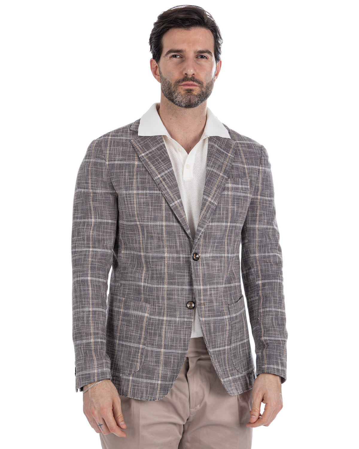 Men's gray plaid linen blazer with notched lapels, two-button closure, paired with white polo and beige trousers.