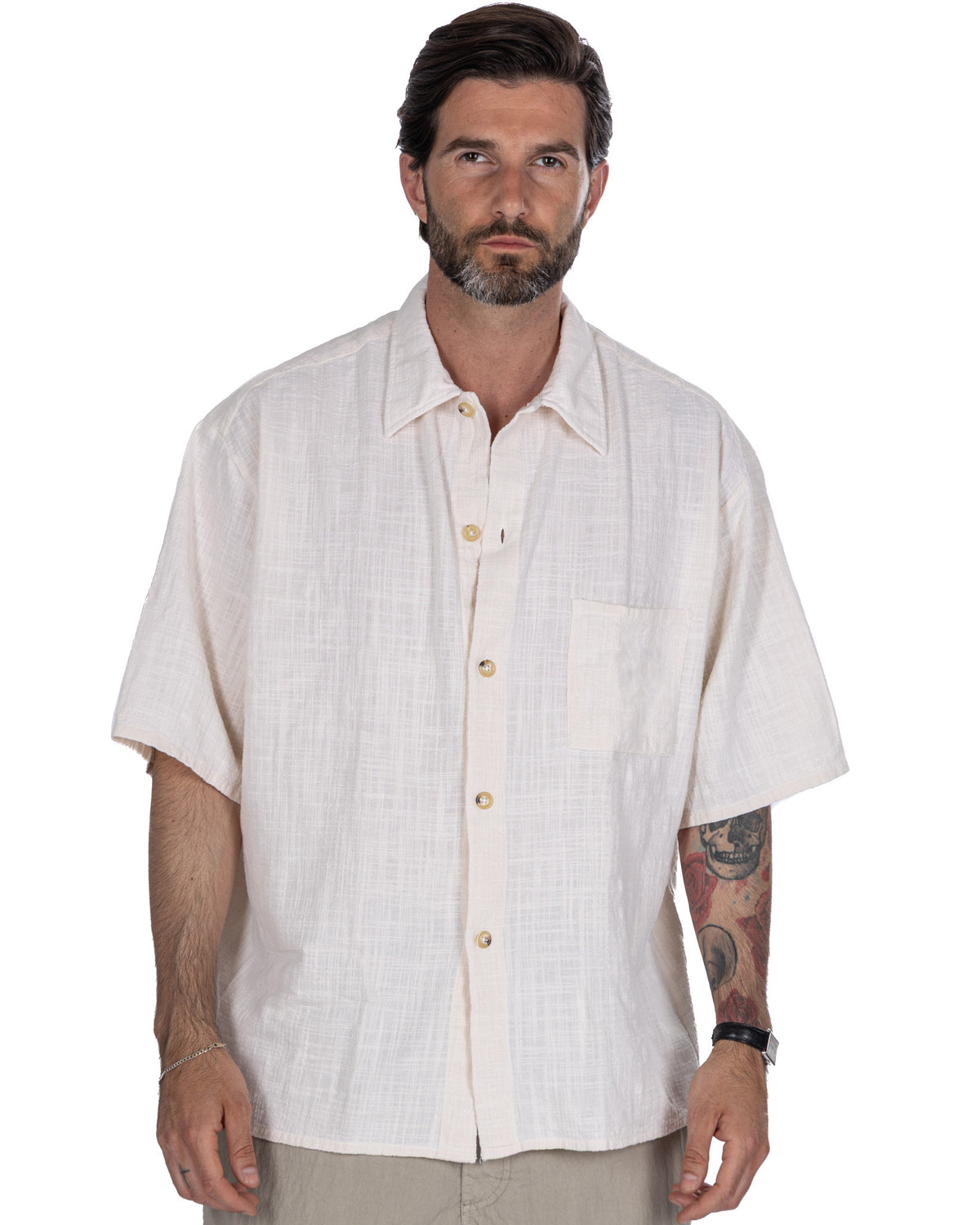 Men's white linen short sleeve button-up shirt with camp collar, chest pocket, and relaxed fit.