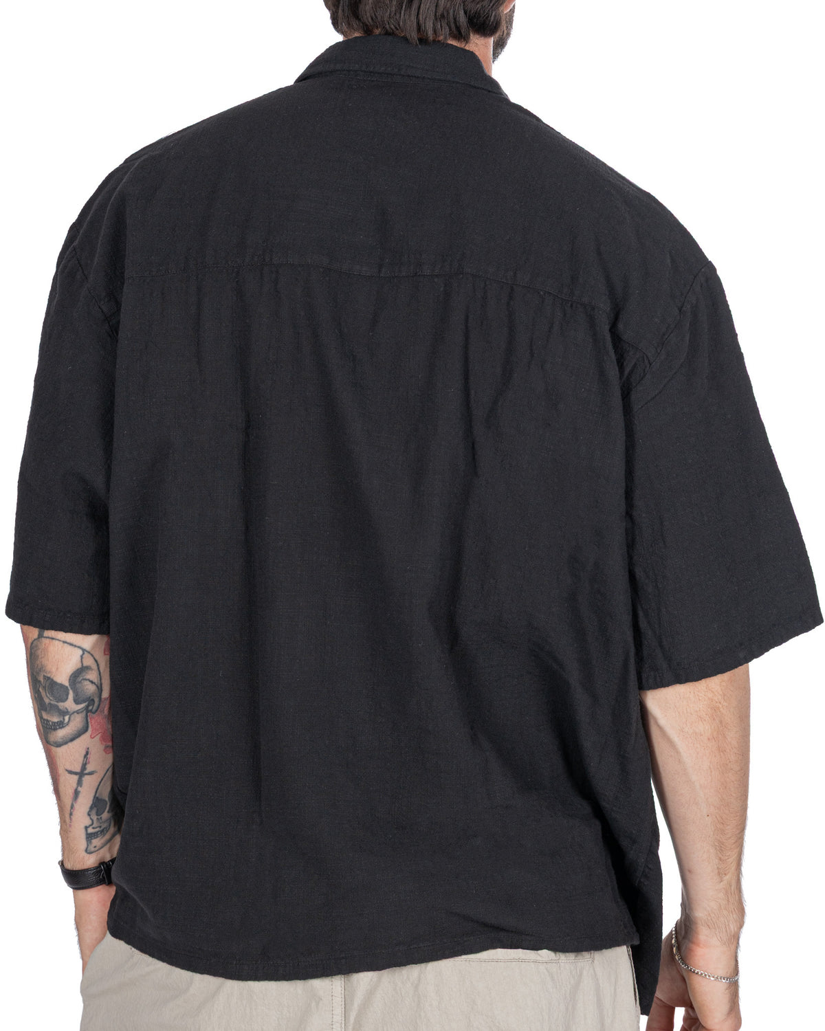 Black short sleeve button-up shirt, relaxed fit, cotton blend fabric, back view.