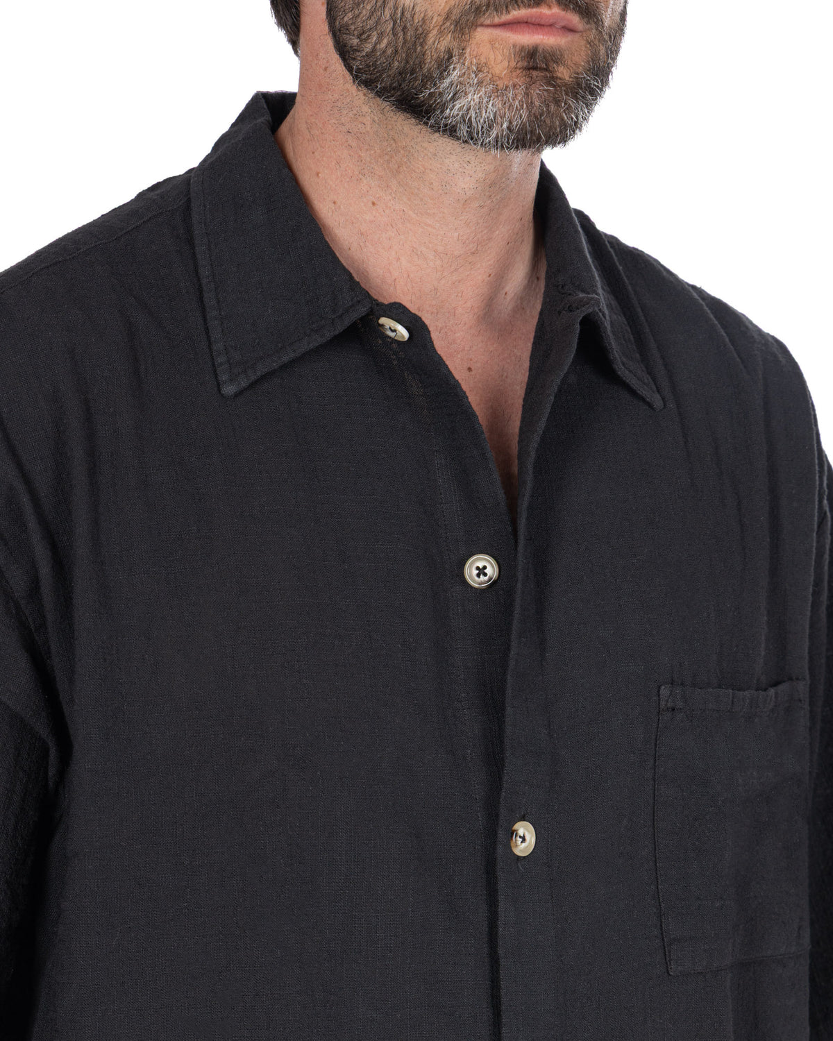 Black linen button-up shirt with gold buttons, collar, and chest pocket. Men's casual summer shirt.