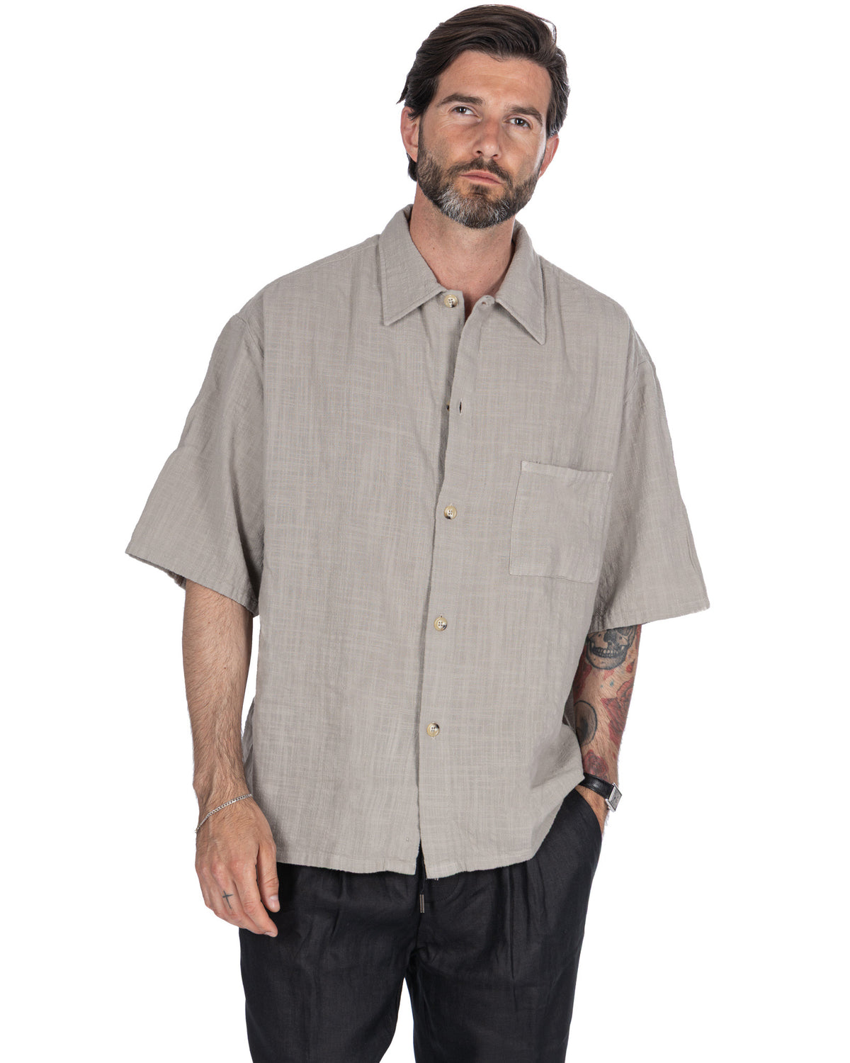 Men's light gray linen short sleeve button-up shirt with relaxed fit, chest pocket, and camp collar.