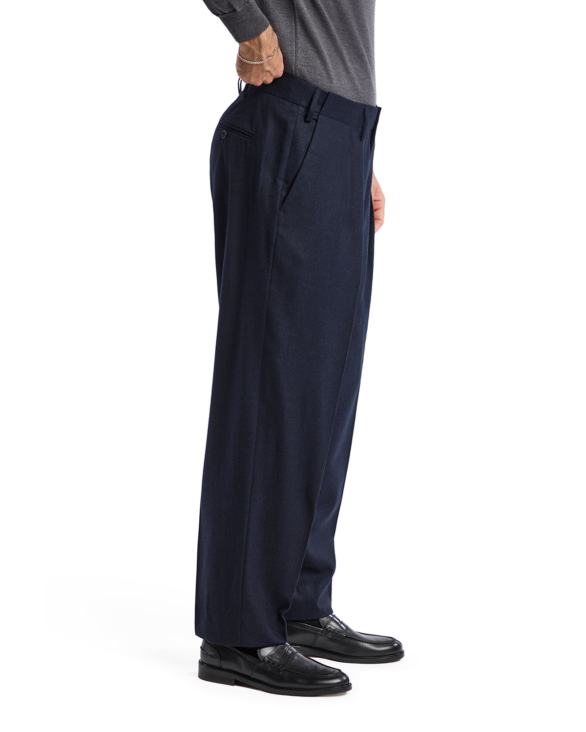 Navy blue wool dress pants for men, featuring a relaxed fit, pleated front, and styled with black leather shoes.