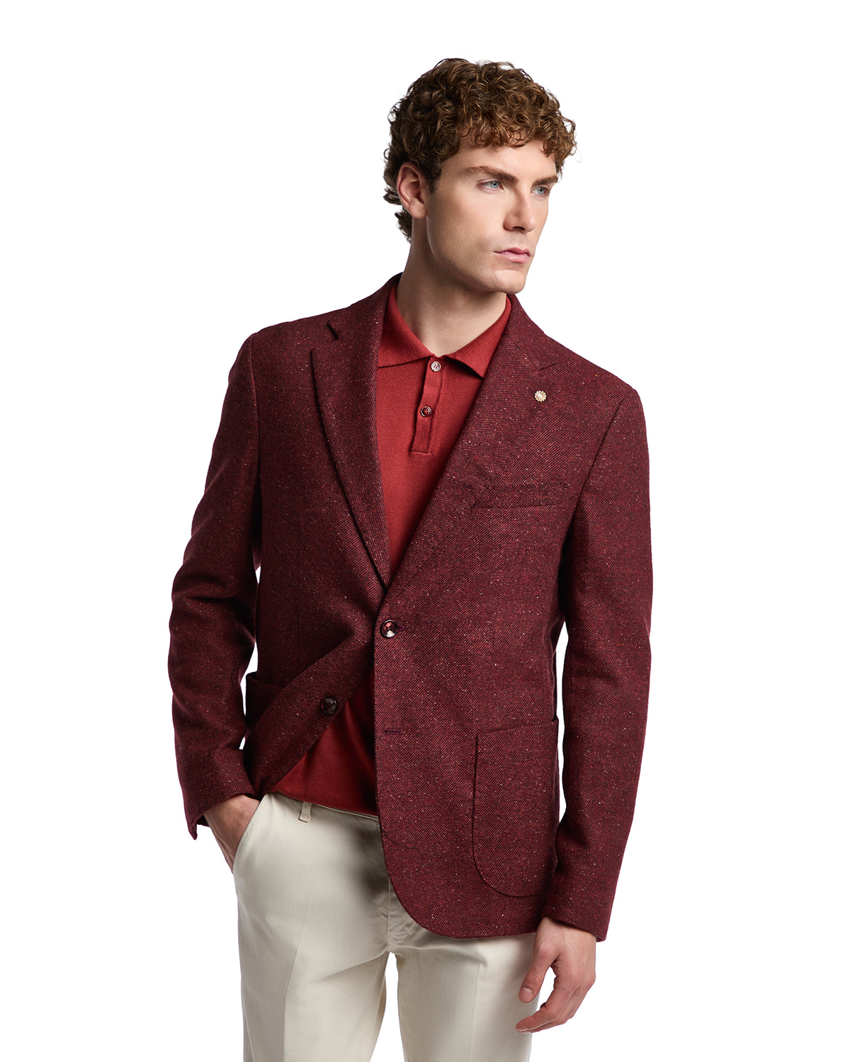 Men's burgundy blazer in textured wool, styled with a red polo shirt and cream trousers for a sophisticated look.
