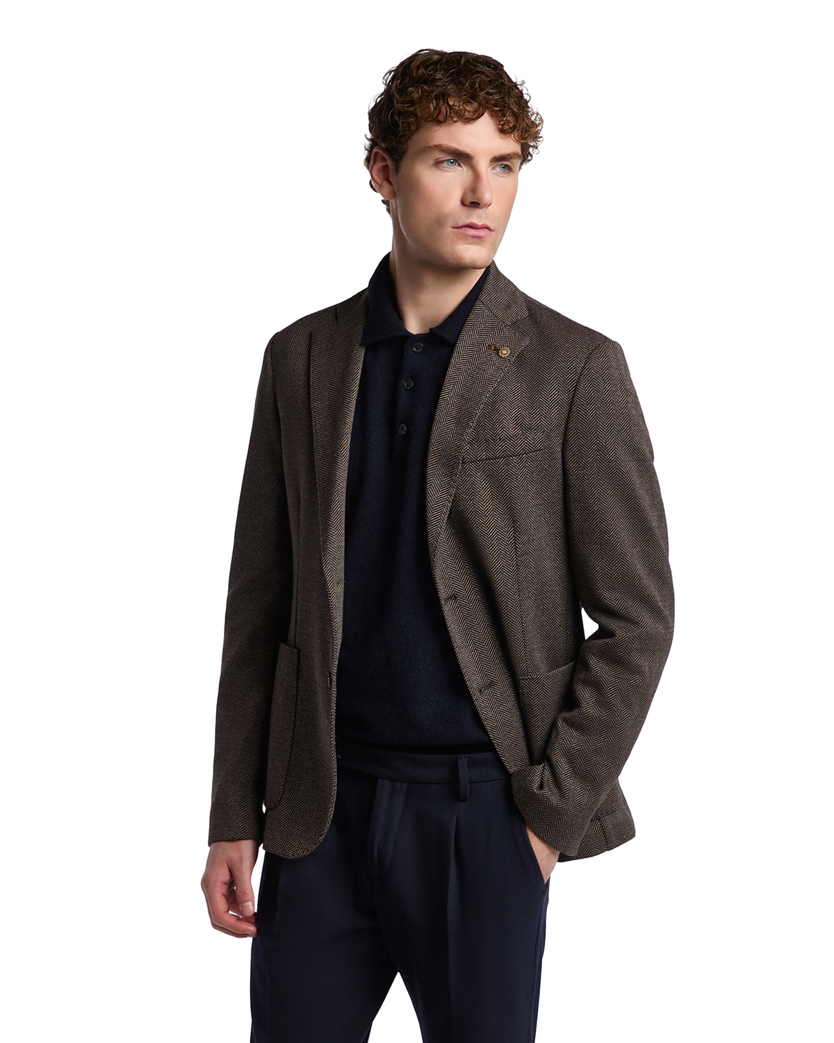 Men's brown tweed blazer with a structured fit, paired with a navy polo shirt for a smart-casual look.