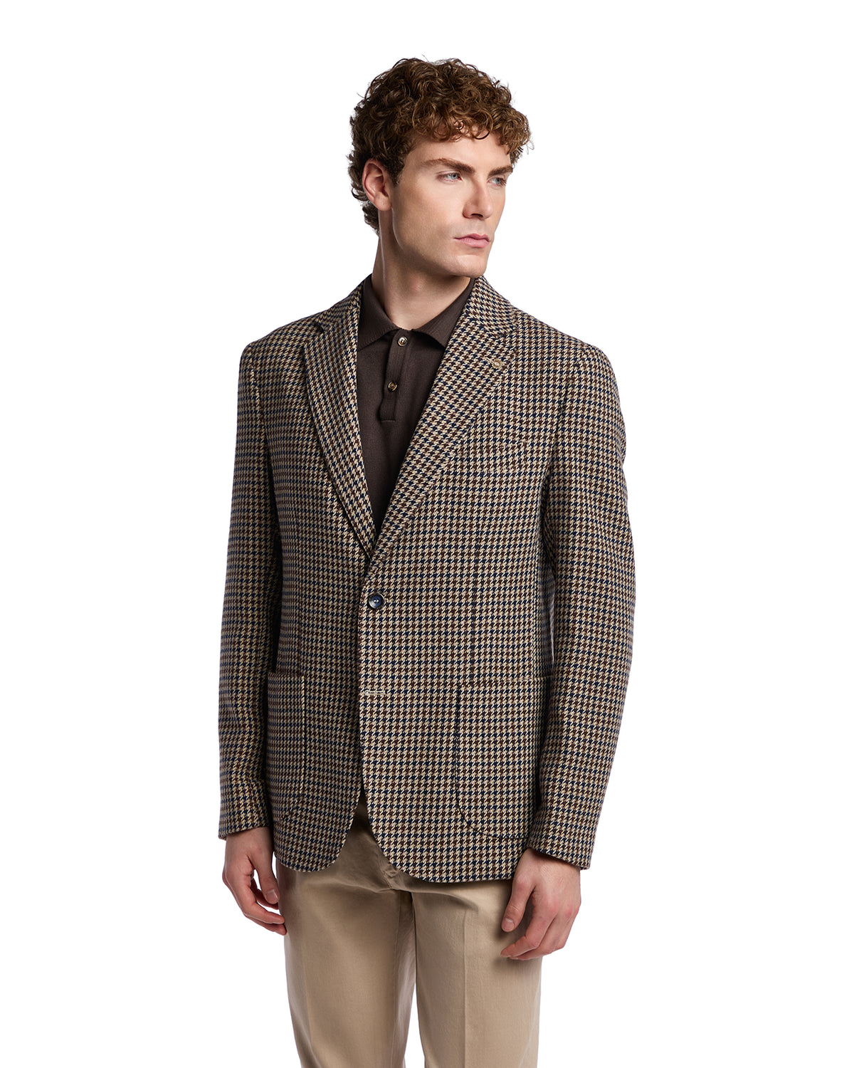 Men's brown houndstooth blazer in wool blend, tailored fit, paired with a dark polo and beige trousers.