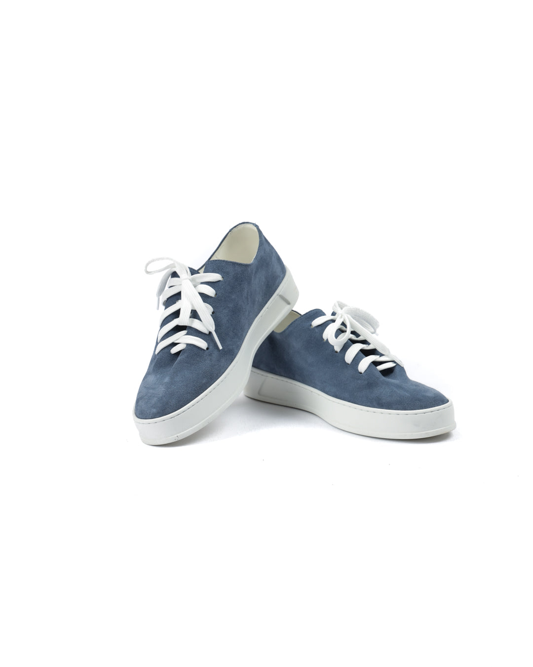 Blue suede sneakers with white laces and rubber soles, perfect for casual, stylish outfits.