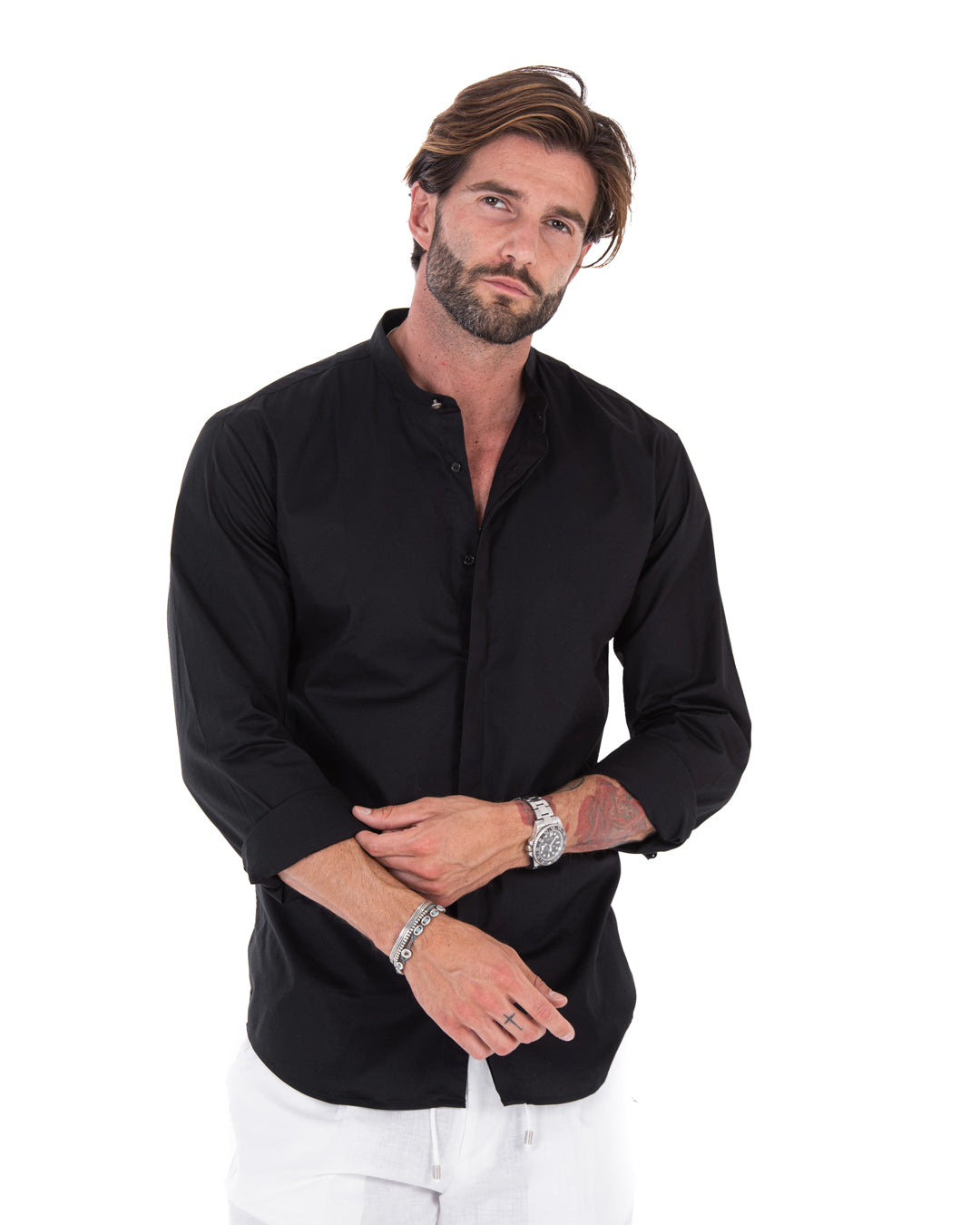 Men's black mandarin-collar shirt with concealed buttons, shown on a model with arms crossed