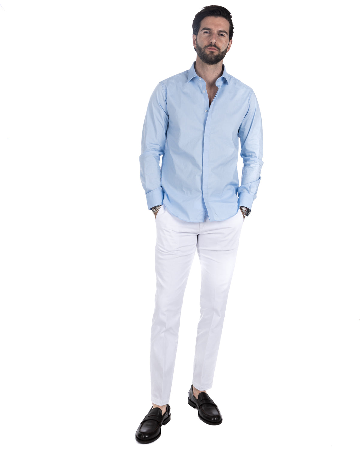 Men's light blue cotton poplin shirt with hidden placket, worn with white trousers and black loafers, front view