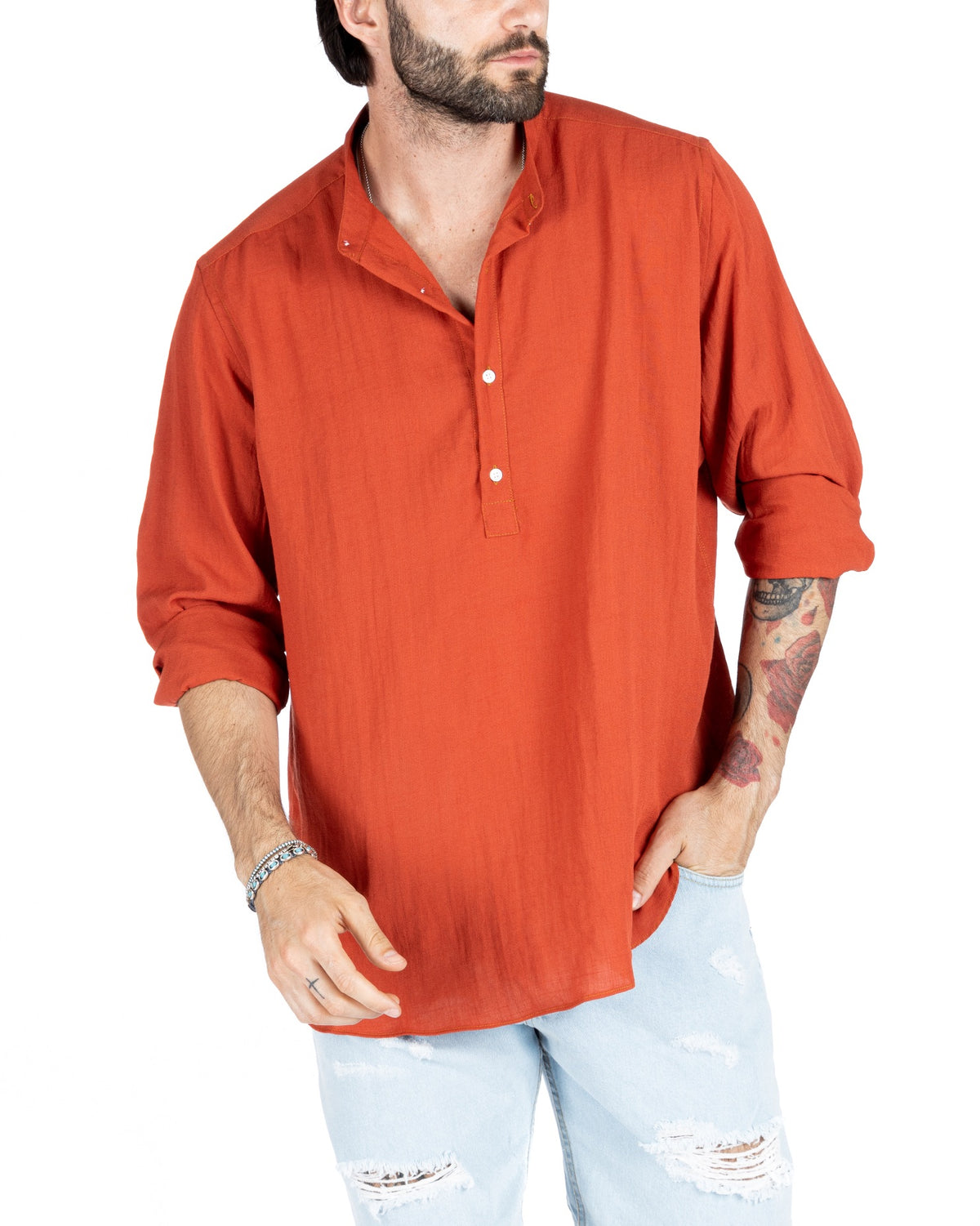 Men's rust orange linen shirt with grandad collar and rolled sleeves, shown on a model with light denim