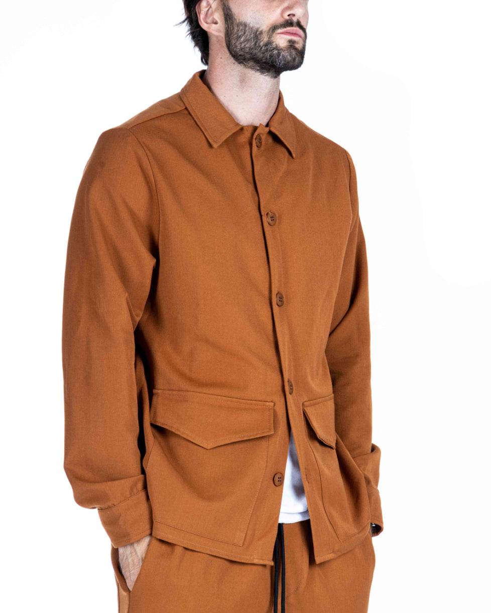 Men's camel overshirt jacket with button placket and patch pockets, shown on a model from a three-quarter angle