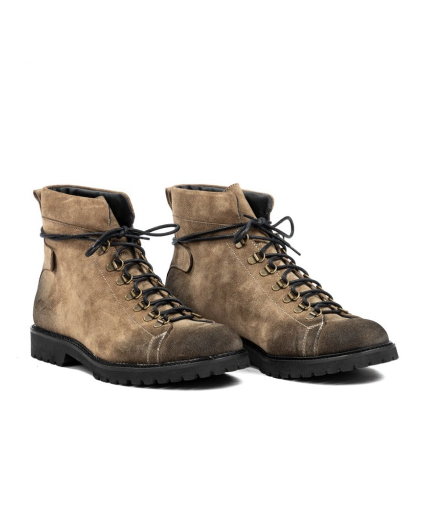 Tan suede leather hiking boots with black laces, gold eyelets, and rugged lug soles.