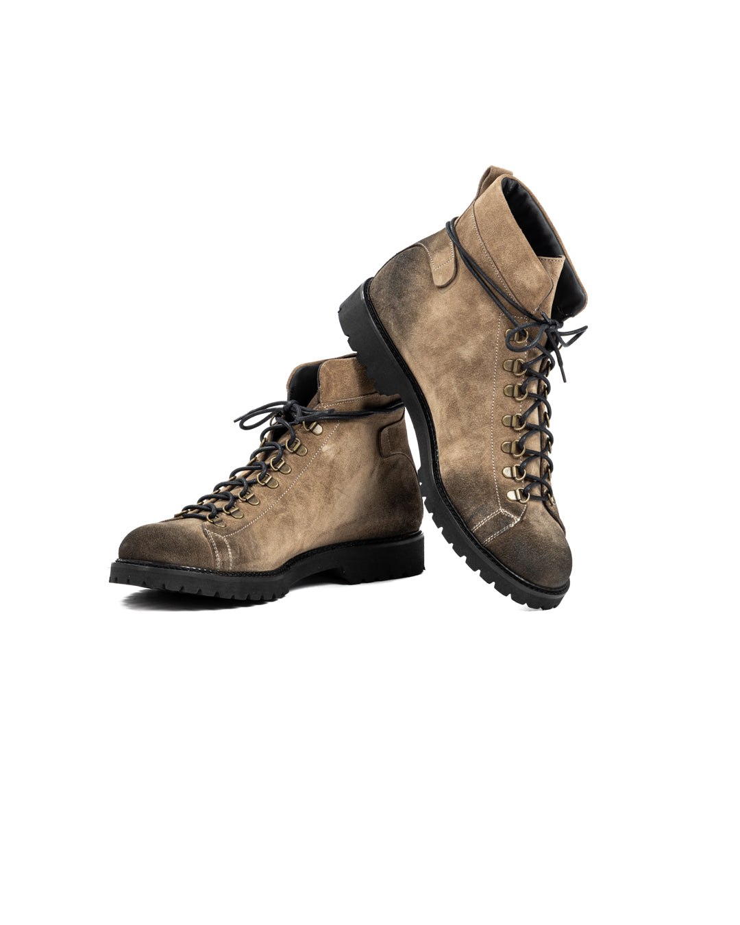Tan suede leather hiking boots with black laces, brass eyelets, and rugged black rubber soles.