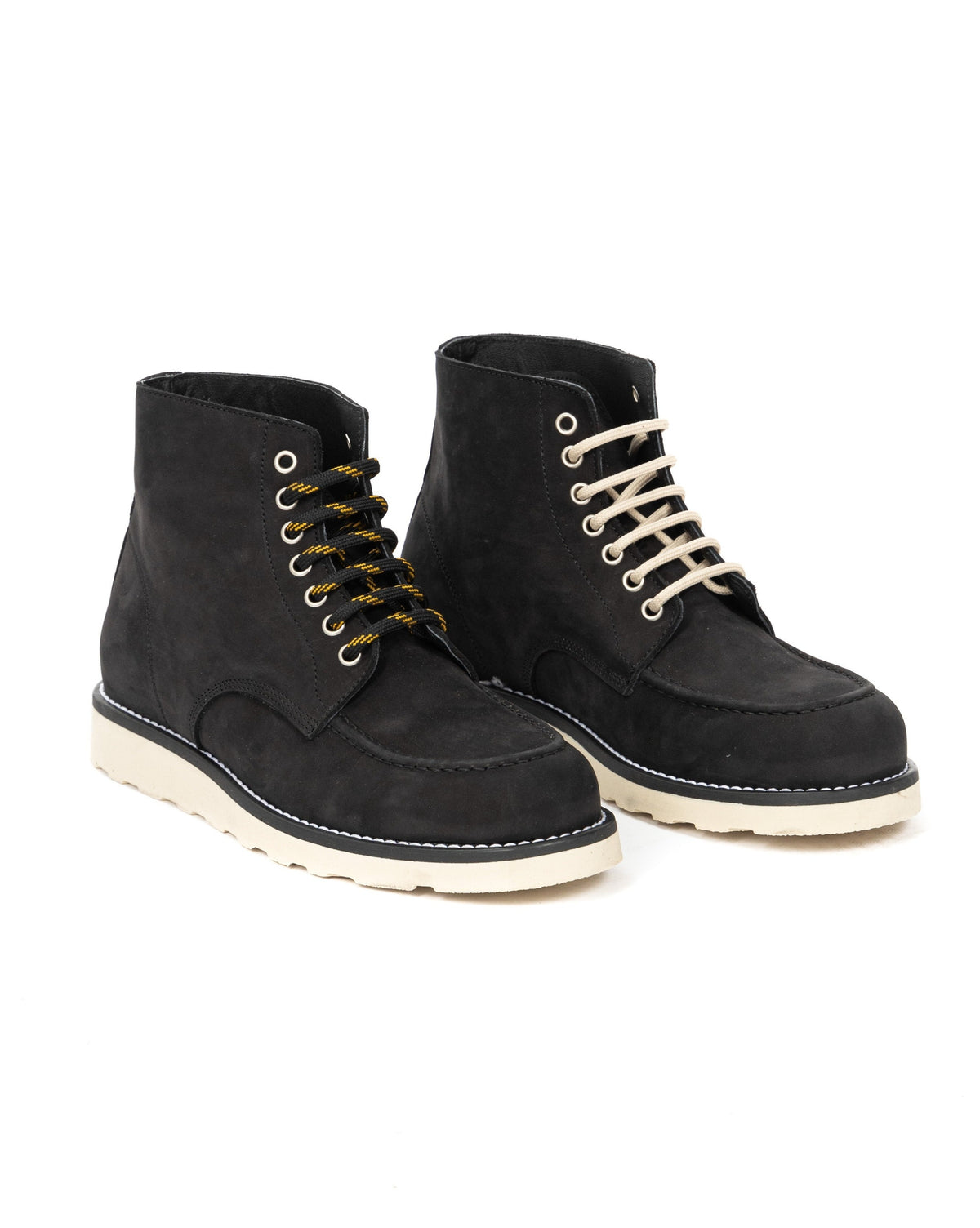Black suede ankle boots with cream soles, featuring contrasting laces and moc-toe stitching detail.