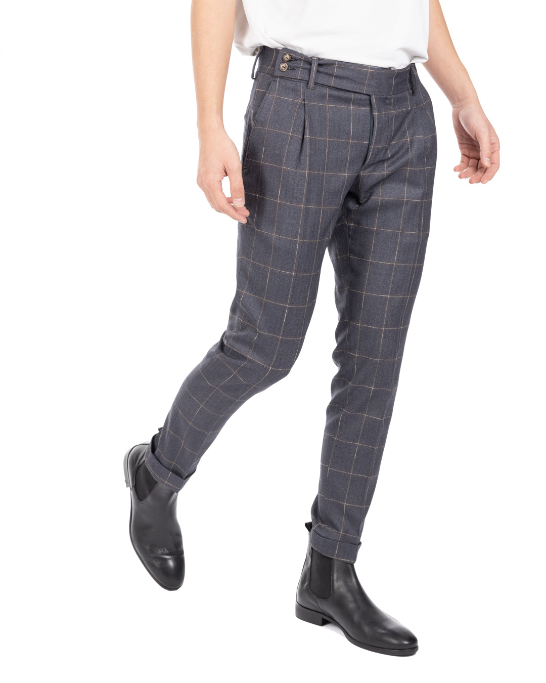 Men's blue-gray windowpane check wool trousers with tapered leg and cuffed hems, worn while walking, side view