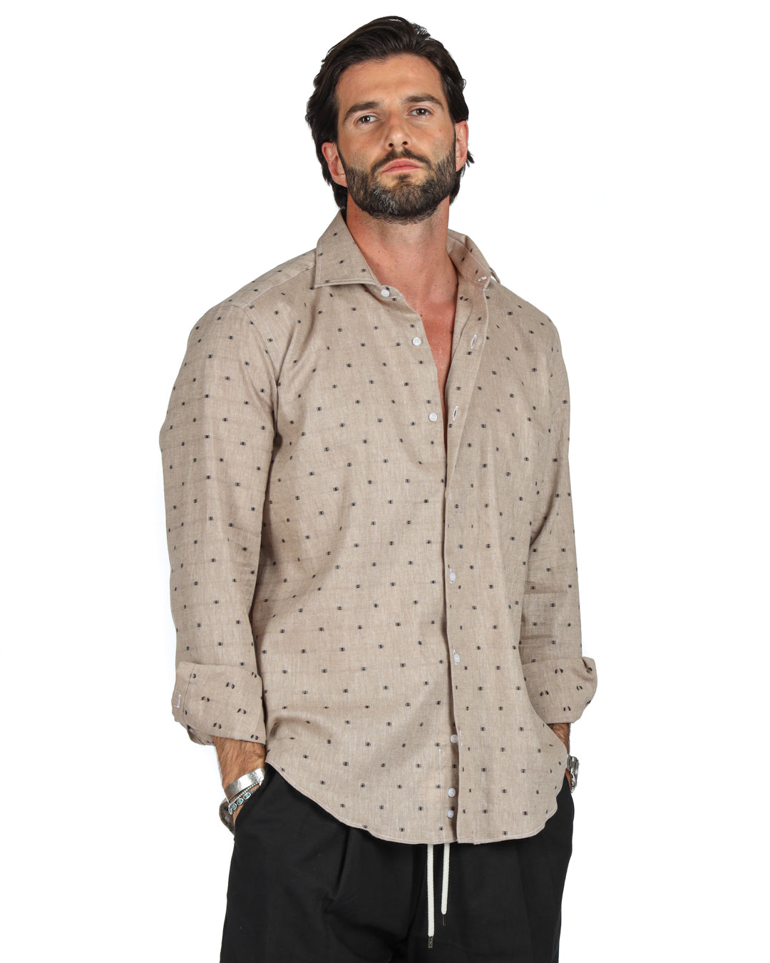 Men's beige linen shirt with brown dot pattern, shown buttoned on a model